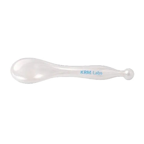 A smooth amber-toned resin facial tool designed to pair with KRM Labs peptide serums for a cooling, spa-like facial massage and smoother serum application.