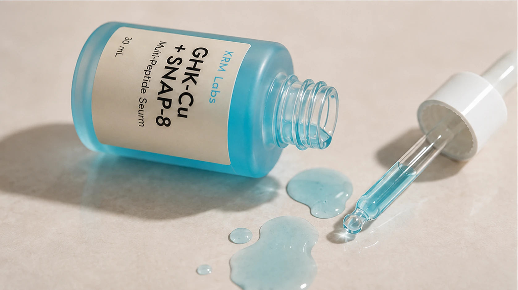 Blue serum bottle with dropper on a beige background