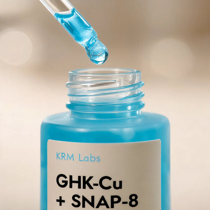 Blue liquid being added to a bottle labeled 'GHK-Cu + SNAP-8' by KRM Labs.