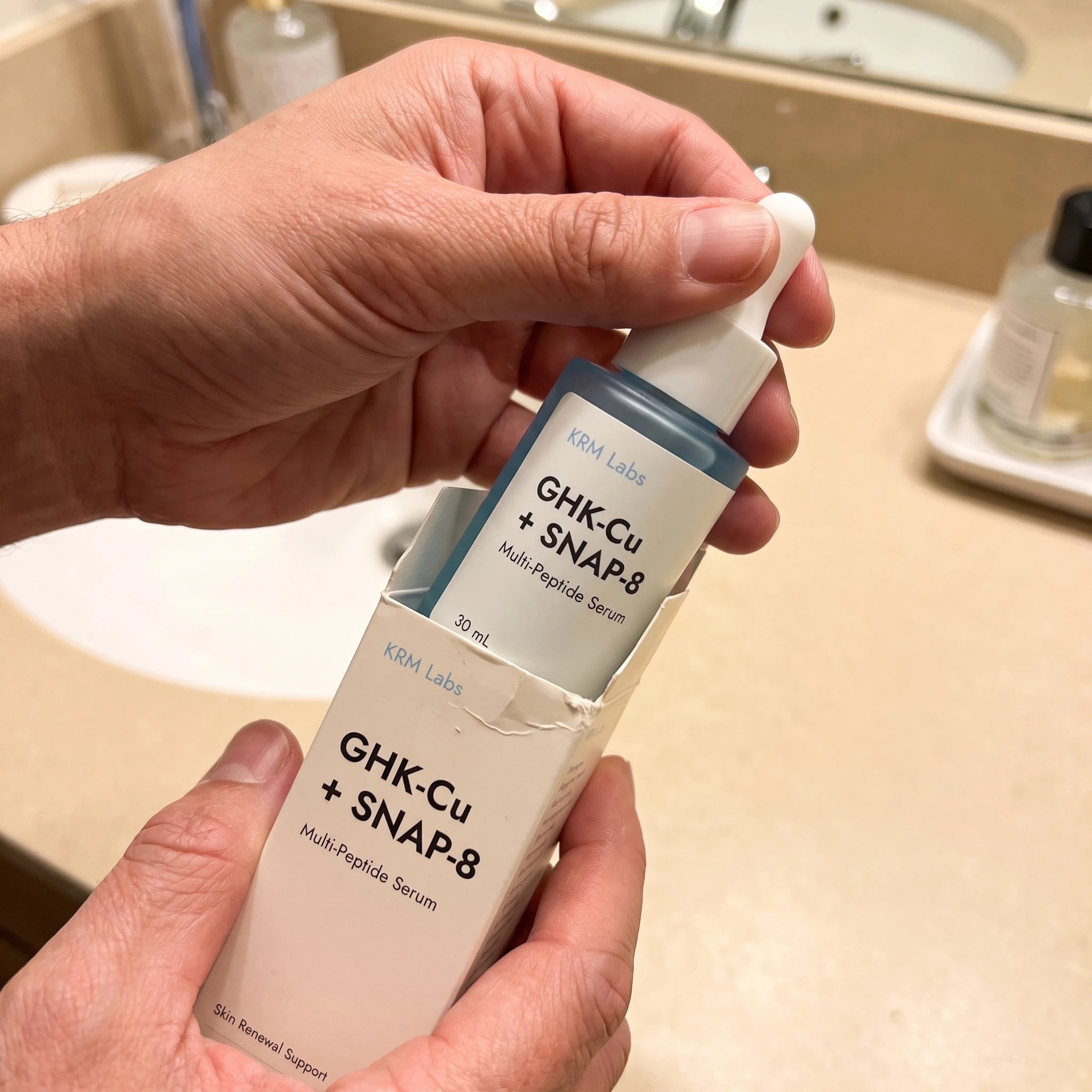 KRM Labs serum shown in a casual bathroom routine setting