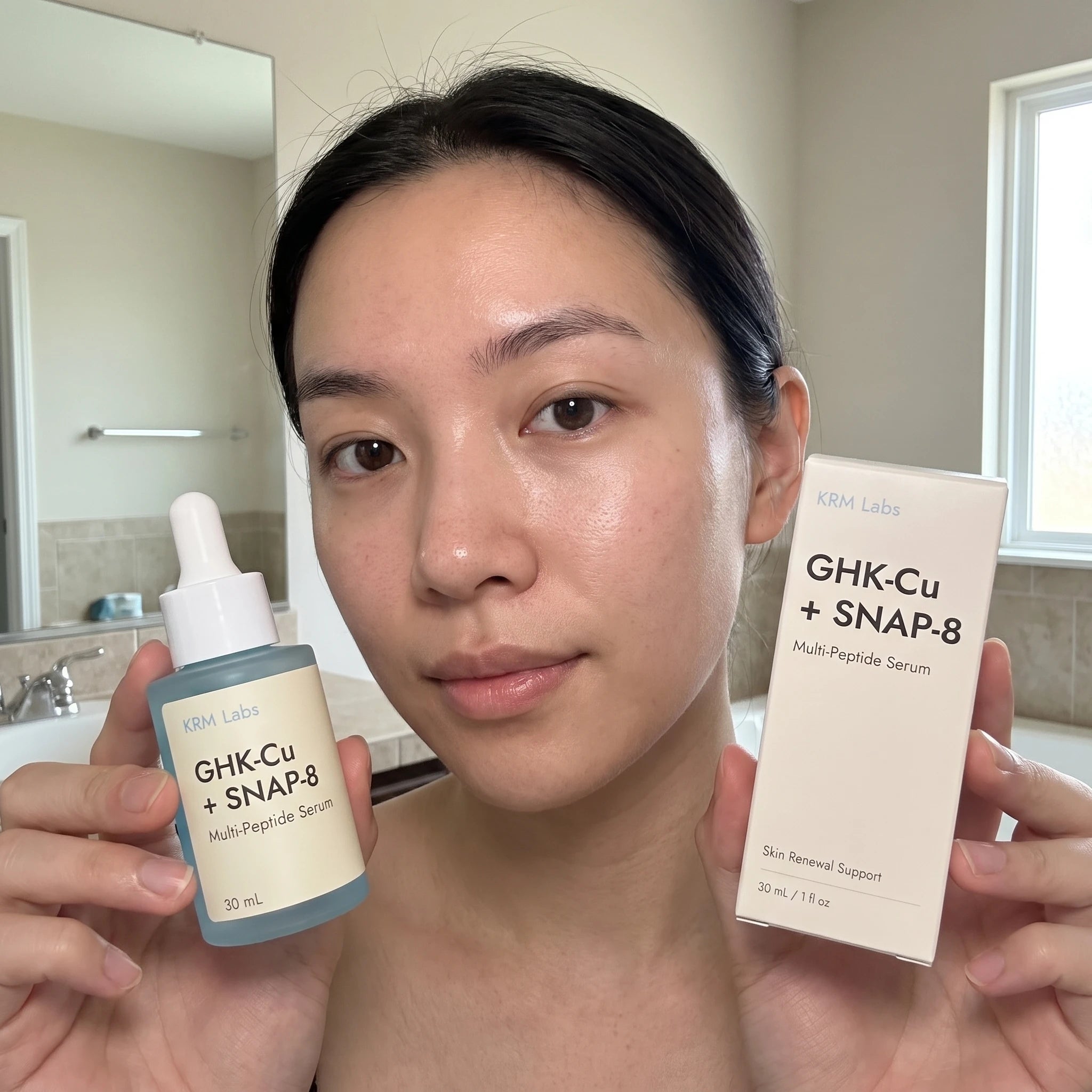 Customer holding KRM Labs serum close to face after shower